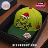 The Grinch Merry Grinchmas 2026 Holiday Cap in lime green with embroidered character face, red Santa hat, and text patch.
