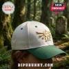 The Legend of Zelda Triforce Embroidered Cap in off-white with a forest green brim and gold Triforce emblem.