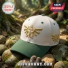The Legend of Zelda Triforce Embroidered Cap in cream white with a forest green brim and gold Triforce logo stitching.