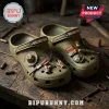The Walking Dead Olive Green Clogs with Charms featuring a miniature sheriff hat, baseball bat, and bloody knife icons.