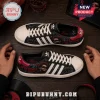 The Weeknd x Adidas After Hours Black Casual Sneakers featuring custom XO graphic prints on a dark textured wood surface.
