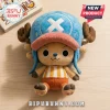 Tony Tony Chopper One Piece stuffed plush toy wearing a blue hat and orange striped shirt on a light wooden background.