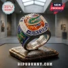 University of Florida Gators Championship Ring with an orange stone, alligator logo, and blue accents on a dark display.