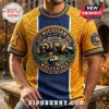 University of Michigan Wolverines NCAA Mascot T-Shirt featuring a wolverine graphic, stadium, and team logo in blue and gold.