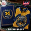 University of Michigan Wolverines Textured Polo Shirt in a blue and yellow box with embossed mascot and team branding.