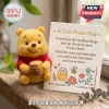 Winnie the Pooh Handmade Felt Pocket Hug holding a honey pot next to a card with an inspirational message and bee artwork.