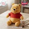 Winnie the Pooh Soft Plush Toy featuring golden yellow fur and a red hoodie sitting on a light wooden tabletop surface.