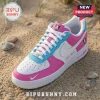 WNBA All Teams Barbie Edition Custom Air Force 1 Sneakers in pink, white, and blue leather resting on a sandy beach.