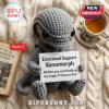 Xenomorph Crochet Emotional Support Plush Toy in gray yarn holding a sign on a cream knit blanket next to tea.