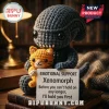 Xenomorph Crochet Emotional Support Plush Toy holding an orange cat plush on a stack of books with text on a white card.