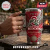 Yeti Ohio State Buckeyes 136th Anniversary YETI Tumbler with red and grey graphics held by a hand on a wooden table.