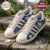 Zeta Phi Beta Howard University White Blue Sneakers with white dove, floral embroidery, and pearl accents on a stone step.