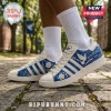 Zeta Phi Beta Howard University white blue sneakers with dove, floral, and 1920 branding on cobblestone background.