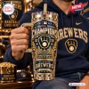 Front view of a 40oz Milwaukee Brewers champions tumbler with blue rhinestones and gold metallic accents held by a person.