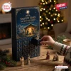 2026 Nativity Story Advent Calendar featuring gold foil illustrations on a navy box with numbered drawers and figurines.