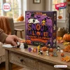 Front view of a 2026 Snoopy Halloween custom advent calendar box on a wooden table with several small festive figurines.