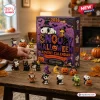 Front view of a 2026 Snoopy Halloween advent calendar with small character ornaments displayed on a wooden table.