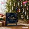 2026 Vodka Advent Calendar box in blue with gold text sits next to a Christmas tree decorated with miniature vodka bottles.