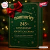 Front view of a green 2026 whiskey advent calendar with a large red bow and gold text on a wooden surface.