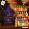 Front view of a purple 2026 whiskey advent calendar bottle shaped container with various miniature spirit bottles nearby.