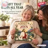 Two women smiling while holding the 2027 A Year With Jesus Wall Calendar in a living room.