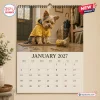 Front view of a 2027 Funny Yorkshire Terrier Wall Calendar featuring a dog in a yellow raincoat for January.