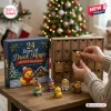 24 Days of Duck Magic Christmas Advent Calendar with wooden drawers and collectible rubber duck figures on a wooden table.