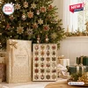 24 Days Of Snowflake Christmas Advent Calendar with twenty-four ornate metal holiday ornaments in a gold display box.