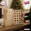 24 Days Of Snowflake Christmas Advent Calendar with gold gift box and individual ornament compartments on wooden table.