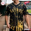All Team MLB x Childhood Cancer Awareness Month black baseball jersey featuring gold ribbons and Astros text on front.