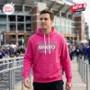 All Team NFL x Crucial Catch Pink Hoodie 2026 featuring the Baltimore Ravens logo and cancer awareness graphics.
