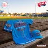 Front view of the blue Amarillo Sod Poodles 2026 Texas League Champions Baseball Jersey resting on a wooden bench.