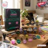 Ateez Golden Hour Part 5 Advent Calendar 2026 box with chibi member figurines and pins displayed on a wooden desk.