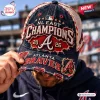 Close-up of a person holding an Atlanta Braves 2026 Champions distressed cap with weathered denim texture and red embroidery.