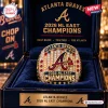 Close-up of a gold Atlanta Braves 2026 NL East Champions ring sitting in a dark blue velvet display box.