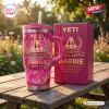 Front view of a pink Yeti tumbler and matching box on a wooden table outdoors.