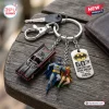 Top view of a Batman 1966 Classic TV Series Batmobile keychain with two character charms and a commemorative metal tag.