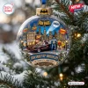 Close-up view of the Batman 1966 Gotham City Christmas Ornament hanging on a snowy pine tree branch.