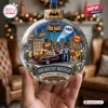 Close-up of a Gotham City Christmas ornament featuring heroes and a car inside a clear sphere.