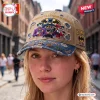 Close-up front view of a person wearing a Batman 87 Years Distressed Denim Cap on a city street.