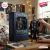 Front view of a Billie Eilish collectible figure standing next to its decorative display box on a wooden desk.