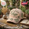 Bitch I'm A Virgo embroidered distressed baseball cap in light pink featuring green astrology patches on a stone table.
