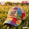 Closeup of a colorful Boho Butterfly Patchwork Baseball Cap sitting in green grass outdoors.