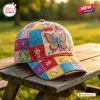 Front view of a Boho Butterfly Patchwork Baseball Cap resting on a wooden bench outdoors.