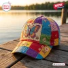 Front view of a Boho Butterfly Patchwork Baseball Cap featuring colorful embroidered panels on a wooden dock.