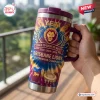 Hand holding Brisbane Lions 2024-2026 YETI Stanley Tumbler with tie-dye pattern.