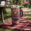 Front view of Brisbane Lions 2024-2026 YETI Stanley Tumbler sitting on a plaid blanket outdoors.