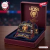 Front view of Brisbane Lions 2026 Three-Peat Championship Cap resting inside a maroon commemorative presentation box.