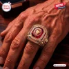 Closeup of a gold Brisbane Lions 2026 Three-Peak Gold Ring worn on a hand.