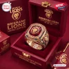 Closeup of Brisbane Lions 2026 Three-Peat Gold Ring resting inside a red collector box.